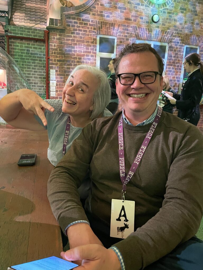 Two people sitting at a table smiling