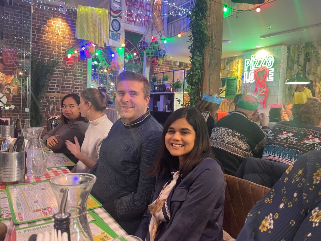 Two people sitting at a table smiling 